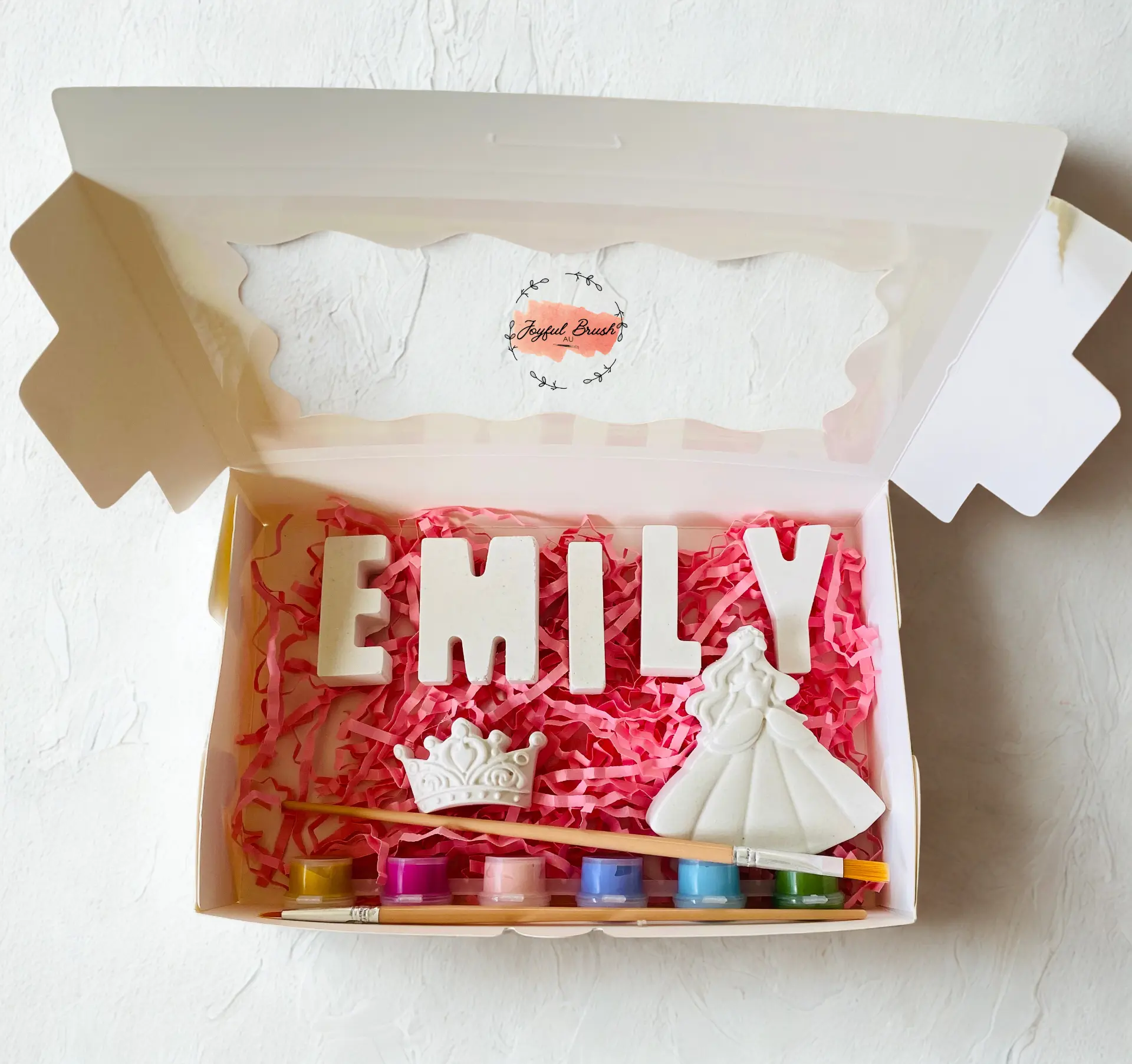 Open personalised Joyful Brush box with Emily plaster letters, a princess dress, crown, paints and brush