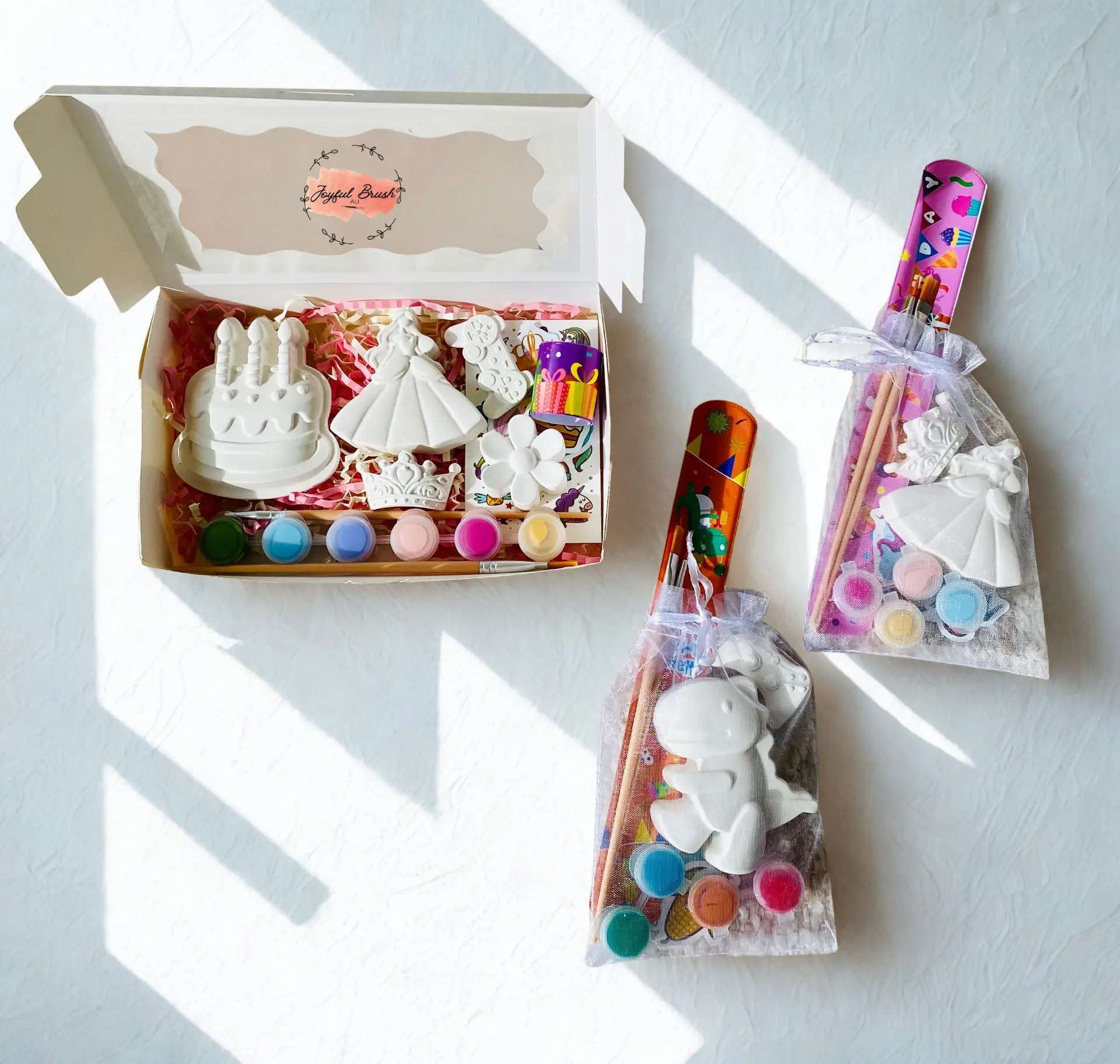 Joyful Brush birthday box displayed with two matching plaster-painting favour bags